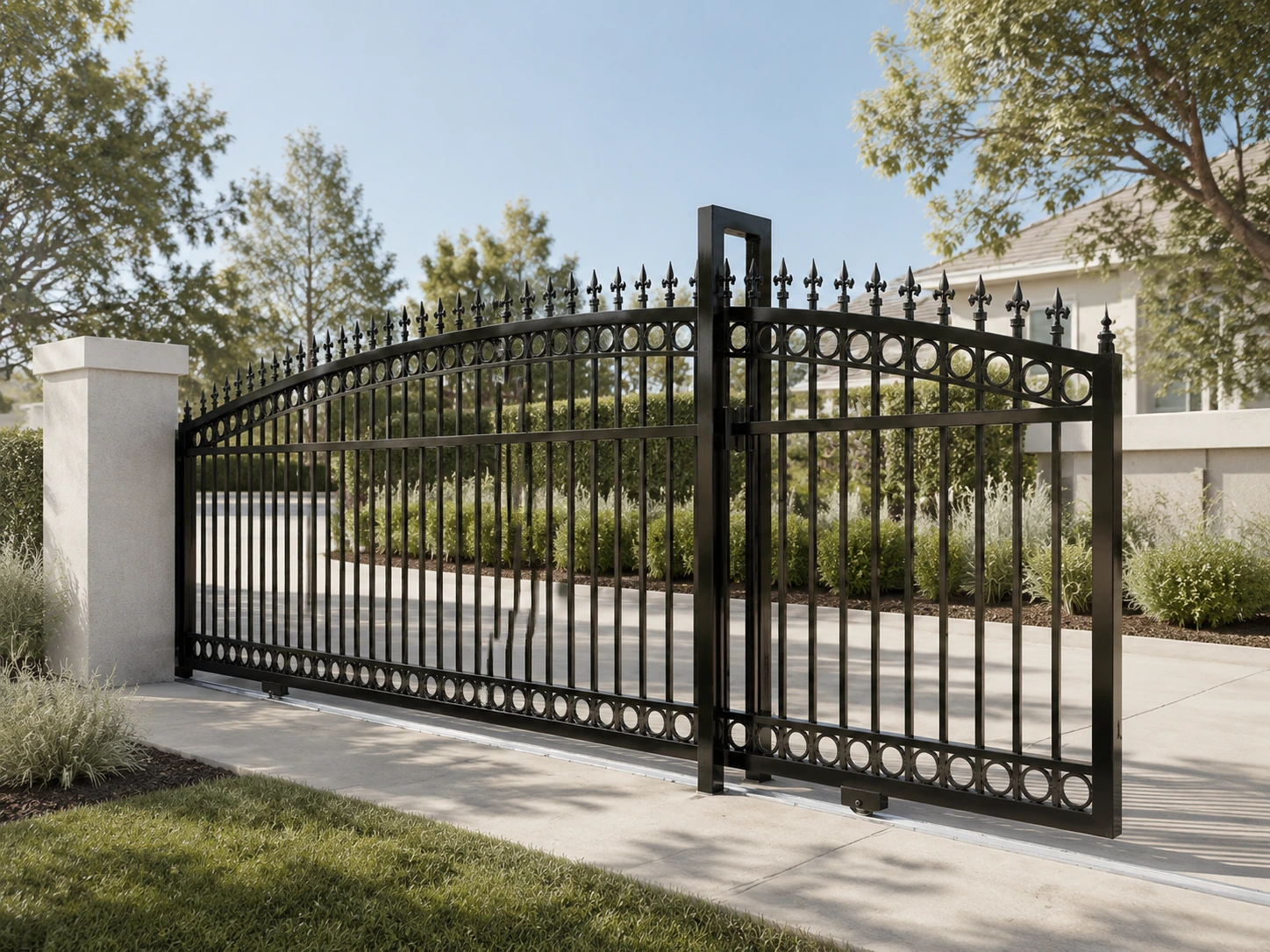 Black ornamental iron fencing and sliding driveway gate